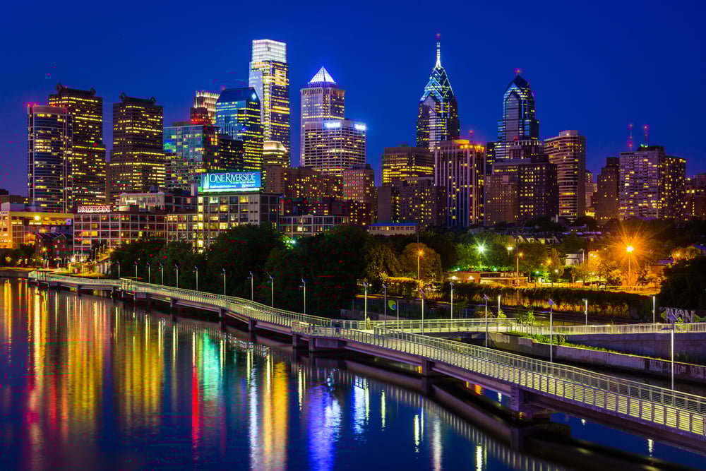 The Philadelphia skyline and Schuylkill River at night, seen from the South Street Bridge in Philadelphia, Pennsylvania.